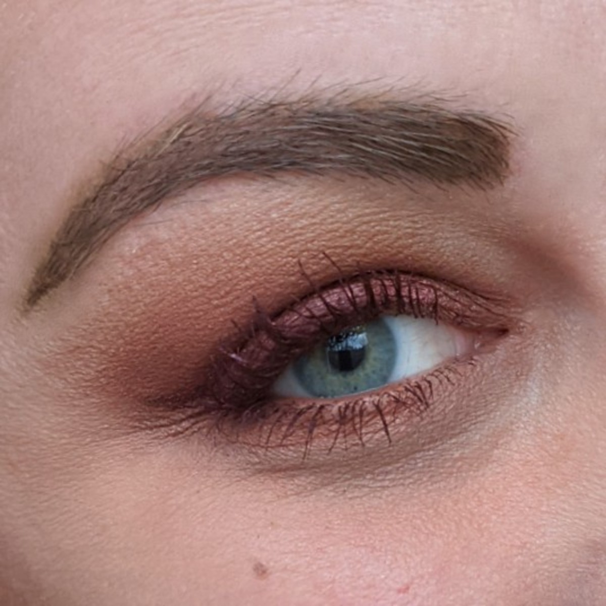 Here's me with a monochromatic red and burgundy makeup look using the Urban Decay Naked Heat Palette and L'Oreal Voluminizing Mascara in Burgundy.