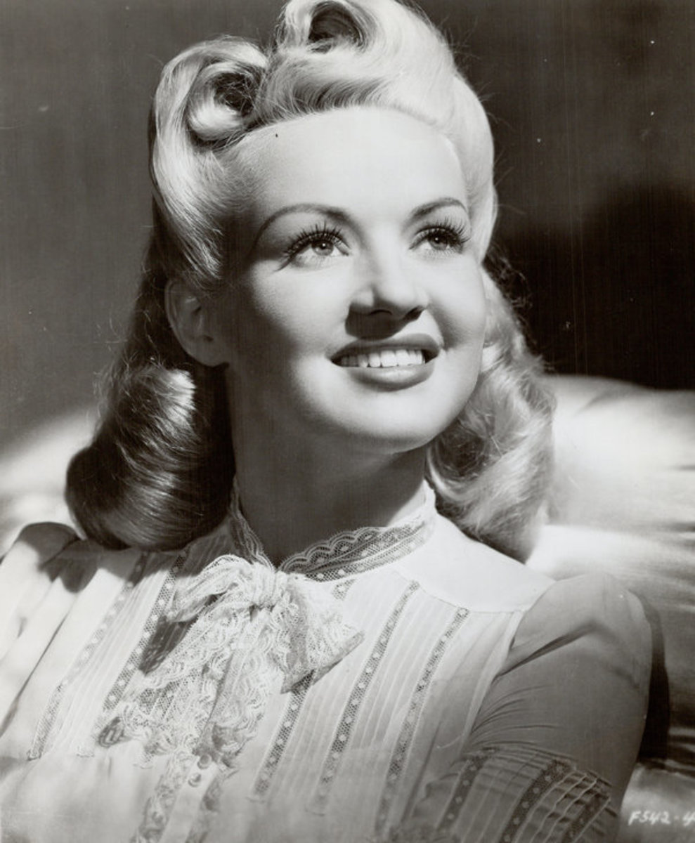 Film star Betty Grable with a long bob that included victory rolls and soft curled ends. 